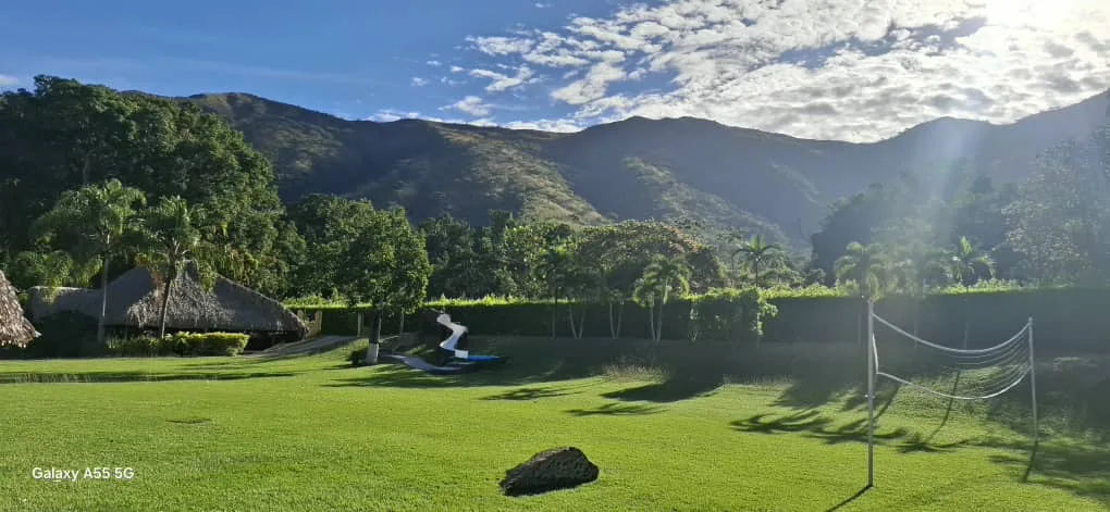 Amplias áreas verdes con montañas de fondo